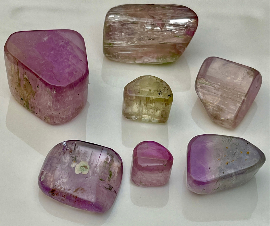 Kunzite polished gemstones showing seven pieces of vary in sizes.