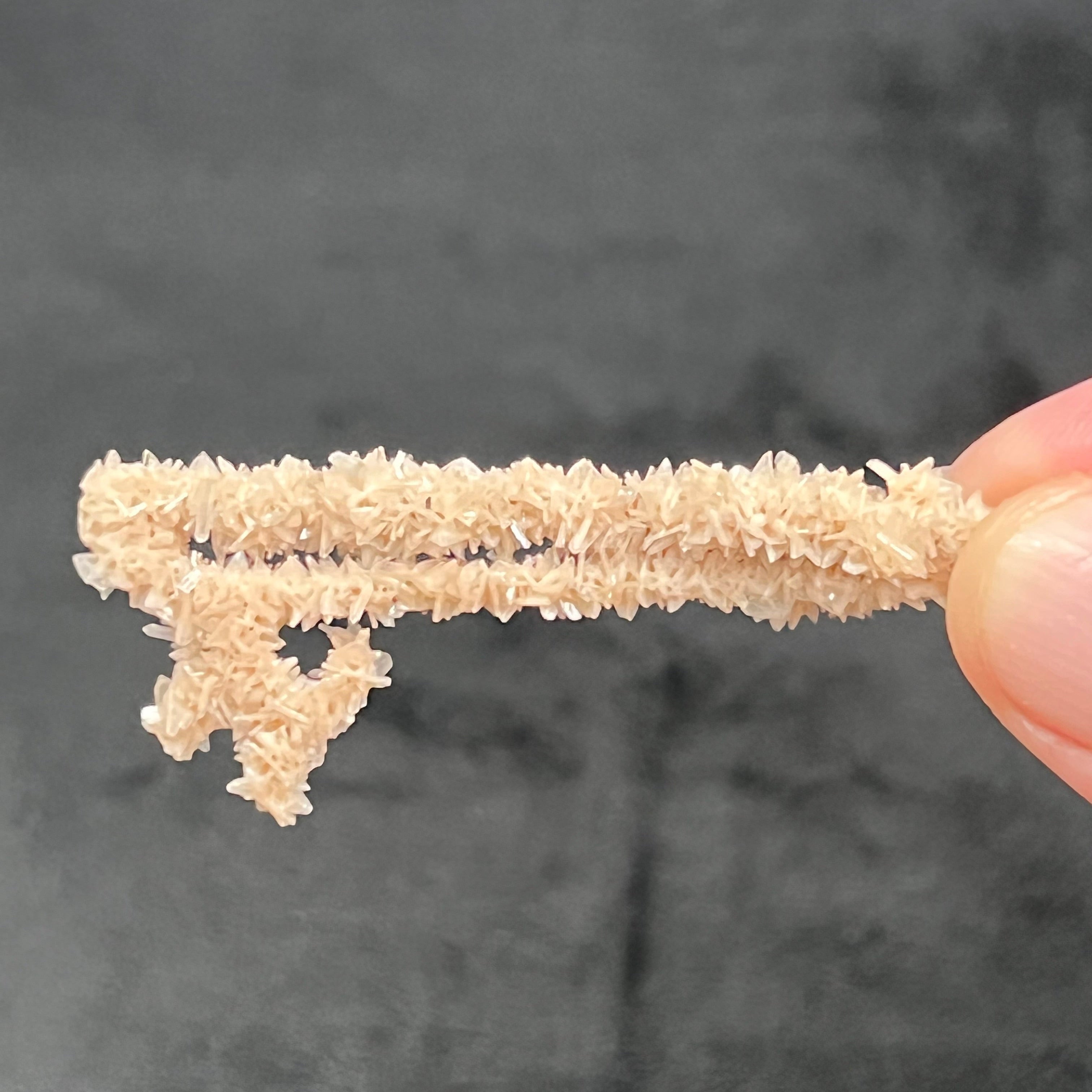 This is an exceptional, truly rare, translucent to transparent, pale to light salmon pink Heulandite with white, some colorless Stilbite and minor Chalcedony Stalactite formation from an old collection. The entire specimen has an intriguing, overall sparkly, old type key shaped appearance.