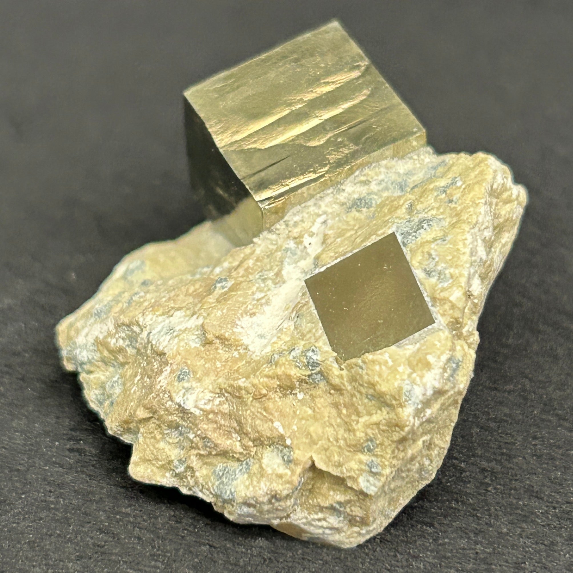 Exhibited is a well formed, beautiful higher quality** crystal specimen with attractive mirror-like metallic luster and fascinating growth patterns on faces. There are two cubes present, one of which is more embedded in matrix.