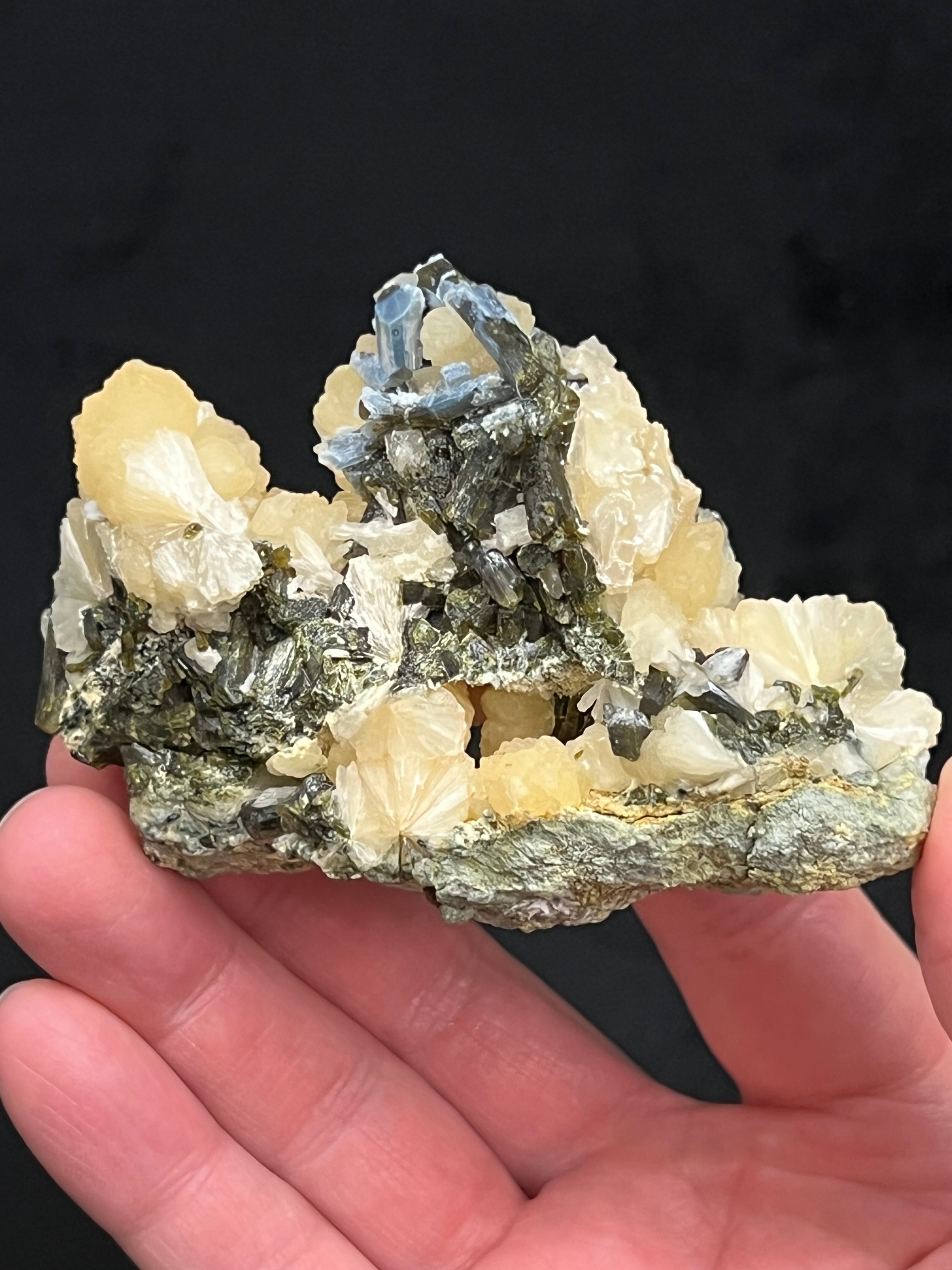 The Epidote in this piece presents throughout the specimen with rich, dark green color, those crystals perched highest exhibiting terminations and a very unusual, fascinating, milky botryoidal Chalcedony!