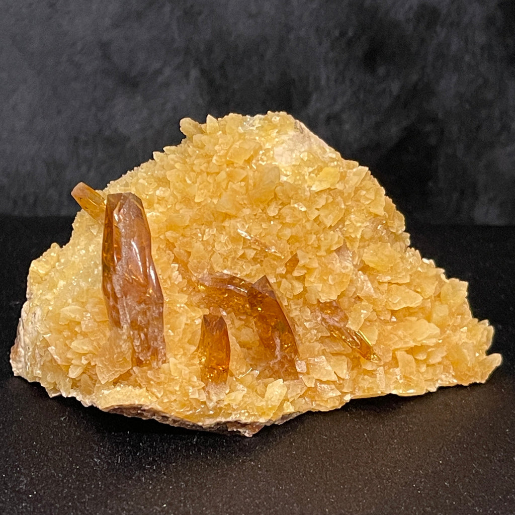The transparent amber or honey colored orthorhombic Barite crystals have a prominent presence on this piece. 