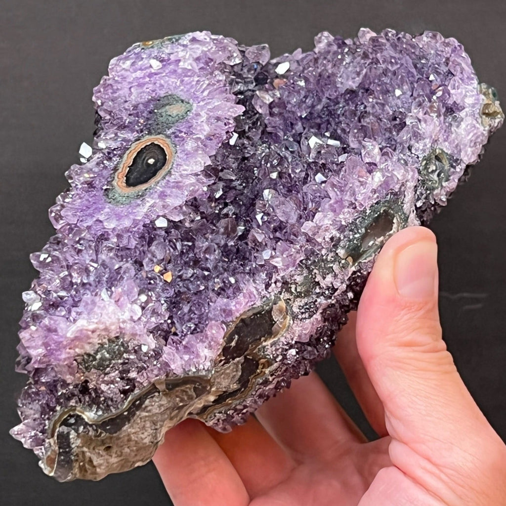 This fine Amethyst Flower Eye specimen features terrific yellow-orange and green banding all the way around the specimen through the matrix and near the base. 