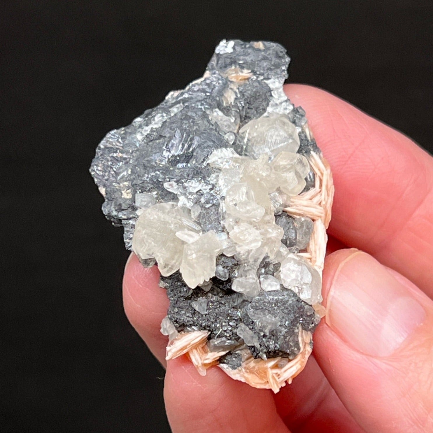 The gray-black Galena is not only the "mother" mineral for the secondary lead carbonate mineral Cerussite, it provides a nice contrast for the orange-pink Barite and Cerussite crystals.
