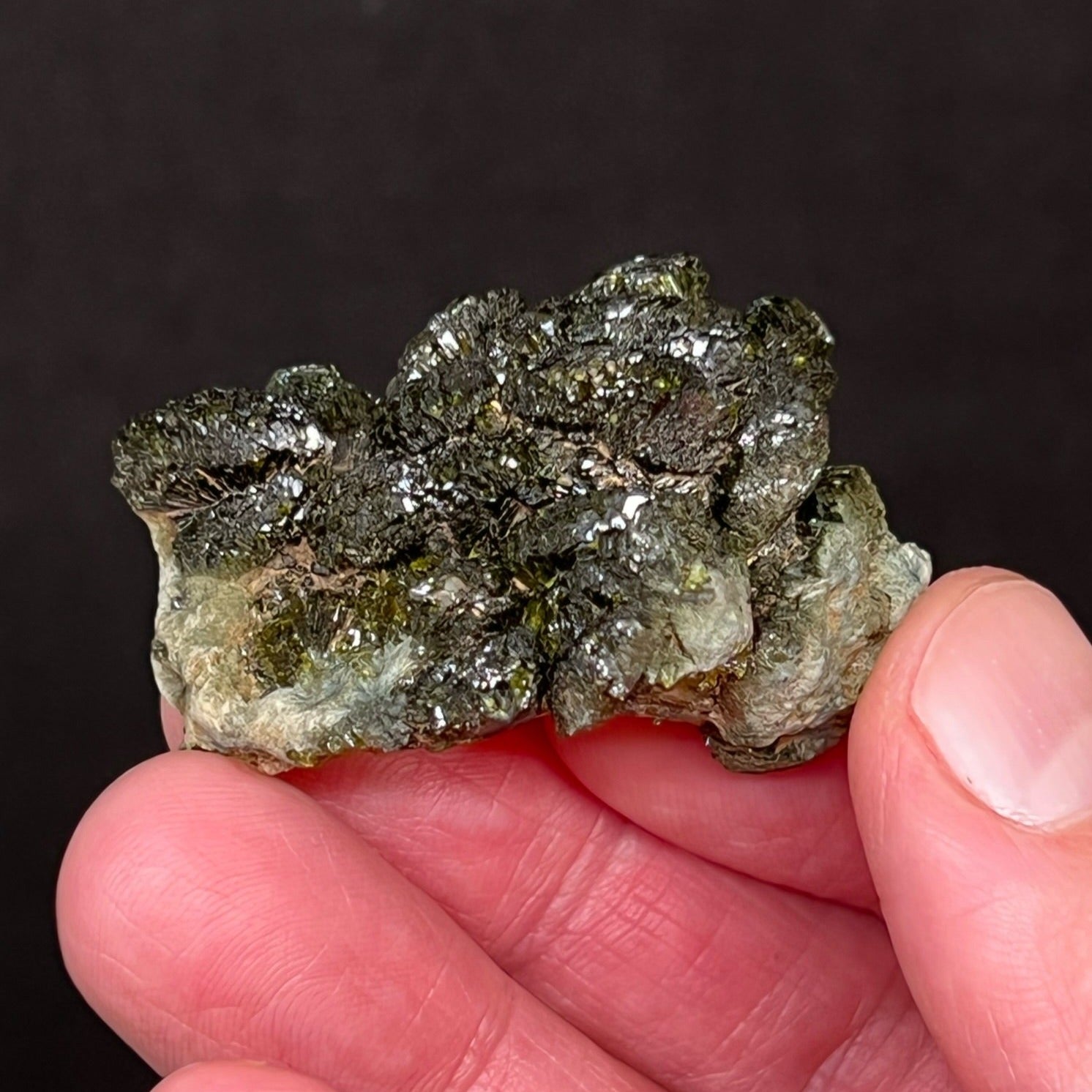 This is a marvelous, quality Epidote specimen with a dark green, lustrous cluster of well formed, prismatic fan-shaped crystals.
