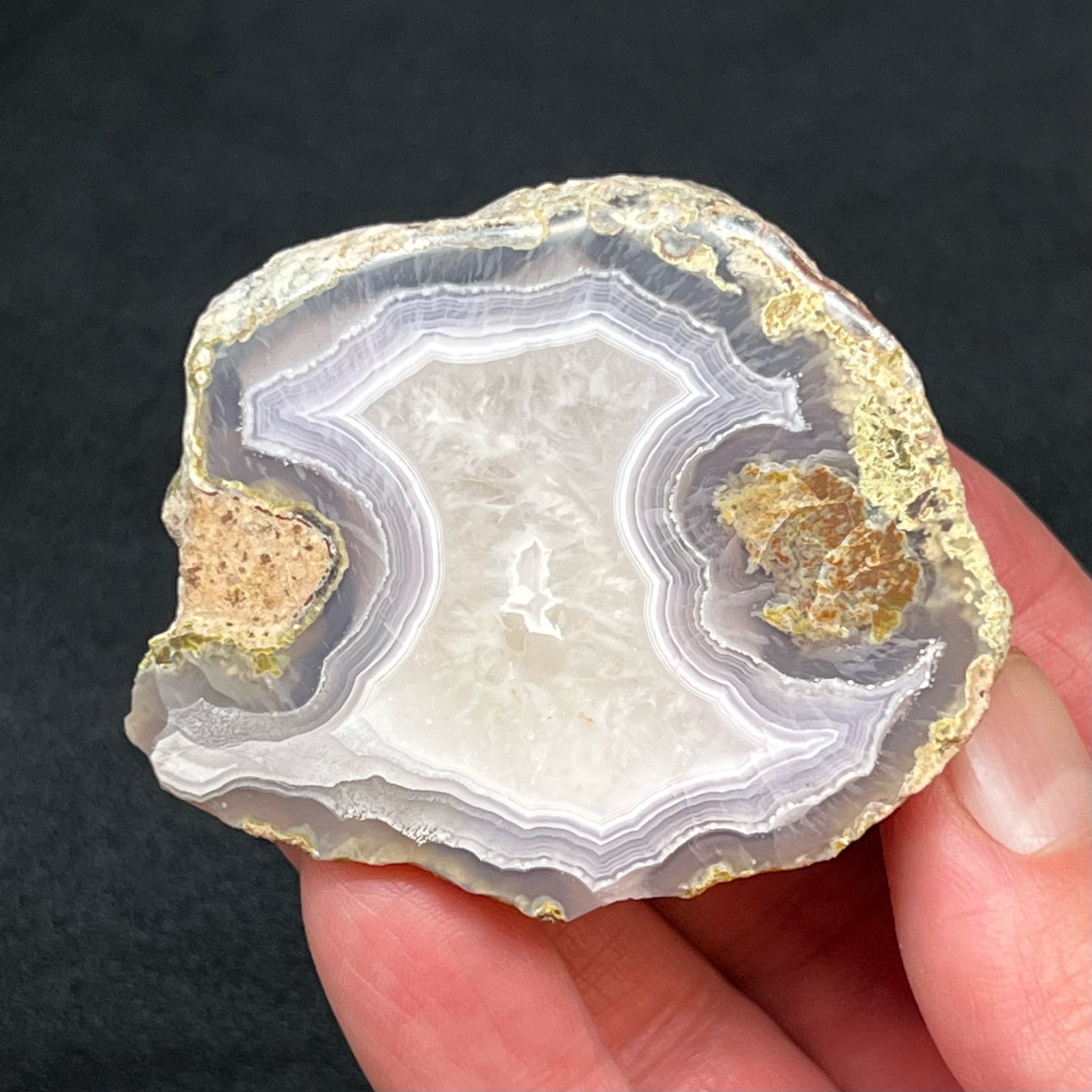 The smaller side of the thunderegg is 97 grams and measures 2.35" x 2.01" x 1.11" or 59.8mm x 51mm x 28.4mm.