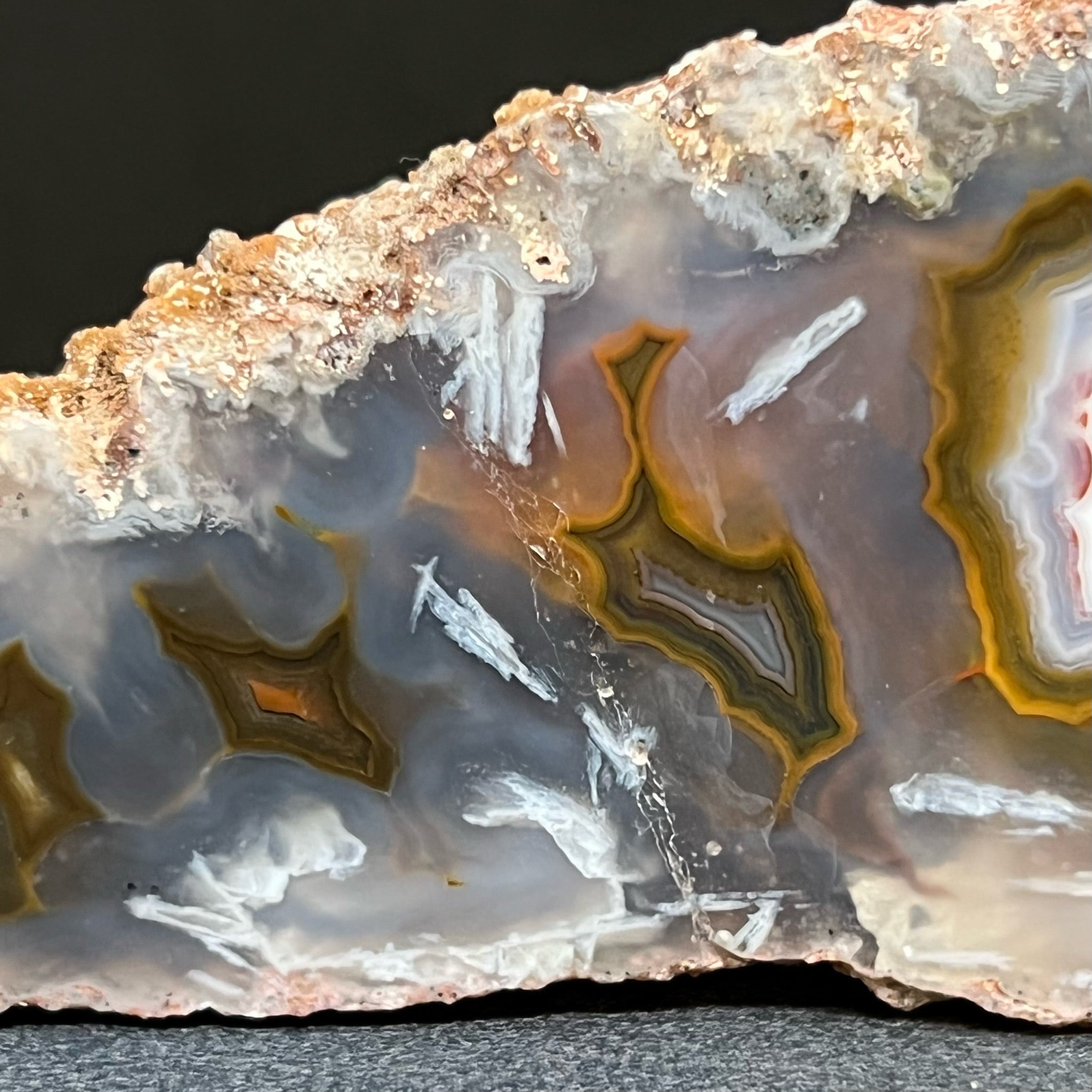 This Moroccan Agate specimen measures 4.9" x 1.68" x 1.13" or 124.6mm x 42.8mm x 28.8mm. The translucent attributes of this specimen present a sort of multidimensional appearance where you can see the intriguing structure of the patterns deeper in the quartz var. chalcedony.