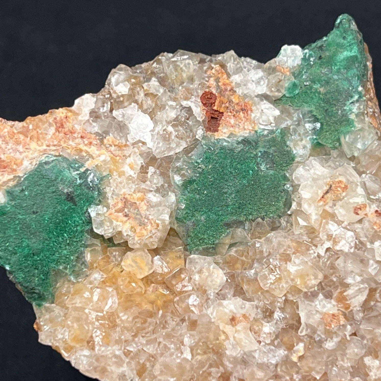 The Malachite in this fine specimen presents both in and on lustrous Quartz that displays as a layer on the matrix.