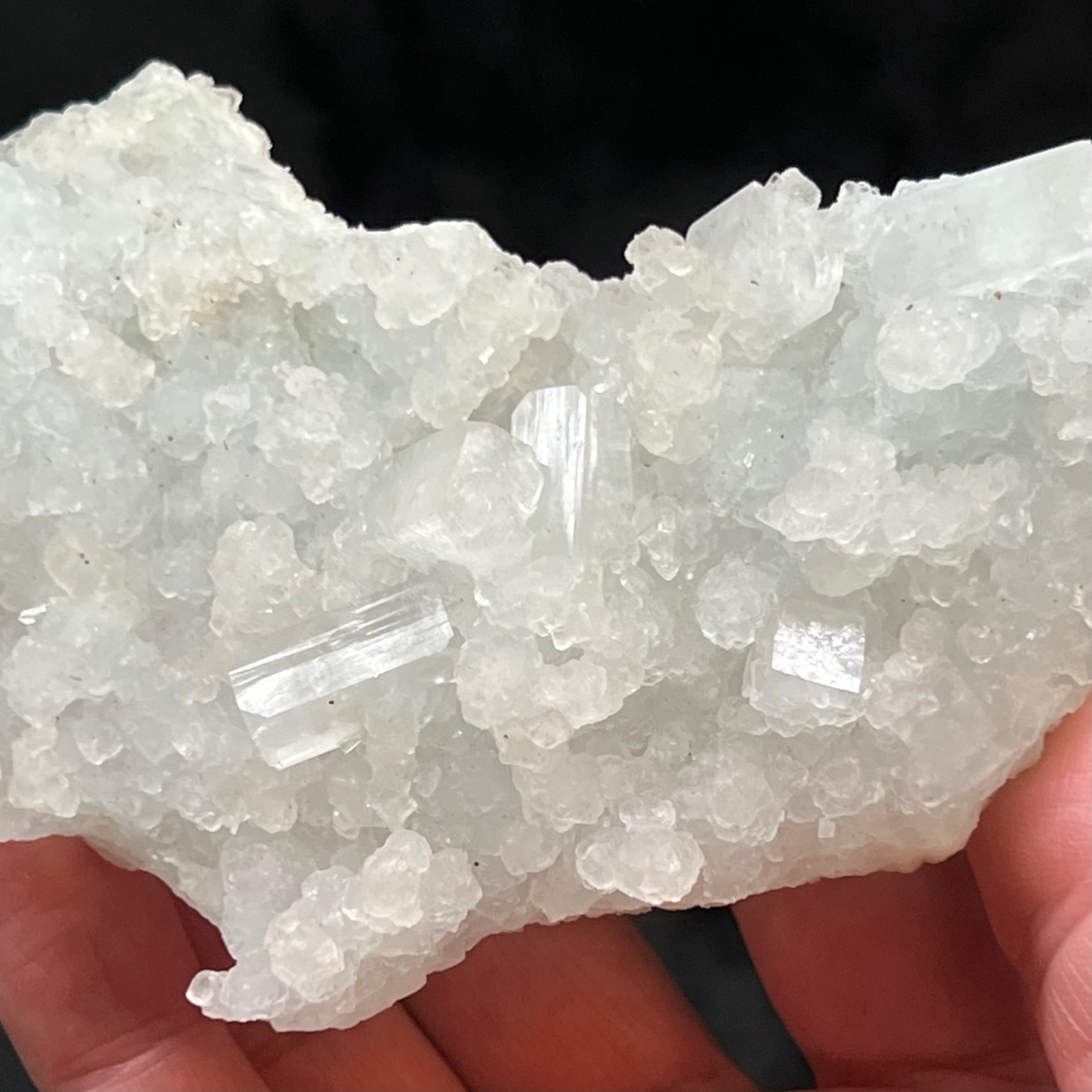 This large Prehnite pseudomorph after Laumontite specimen with lustrous Apophyllite crystals features fascinating finger-like stalks, some stalactite-like, of pale, light blue-green Prehnite.