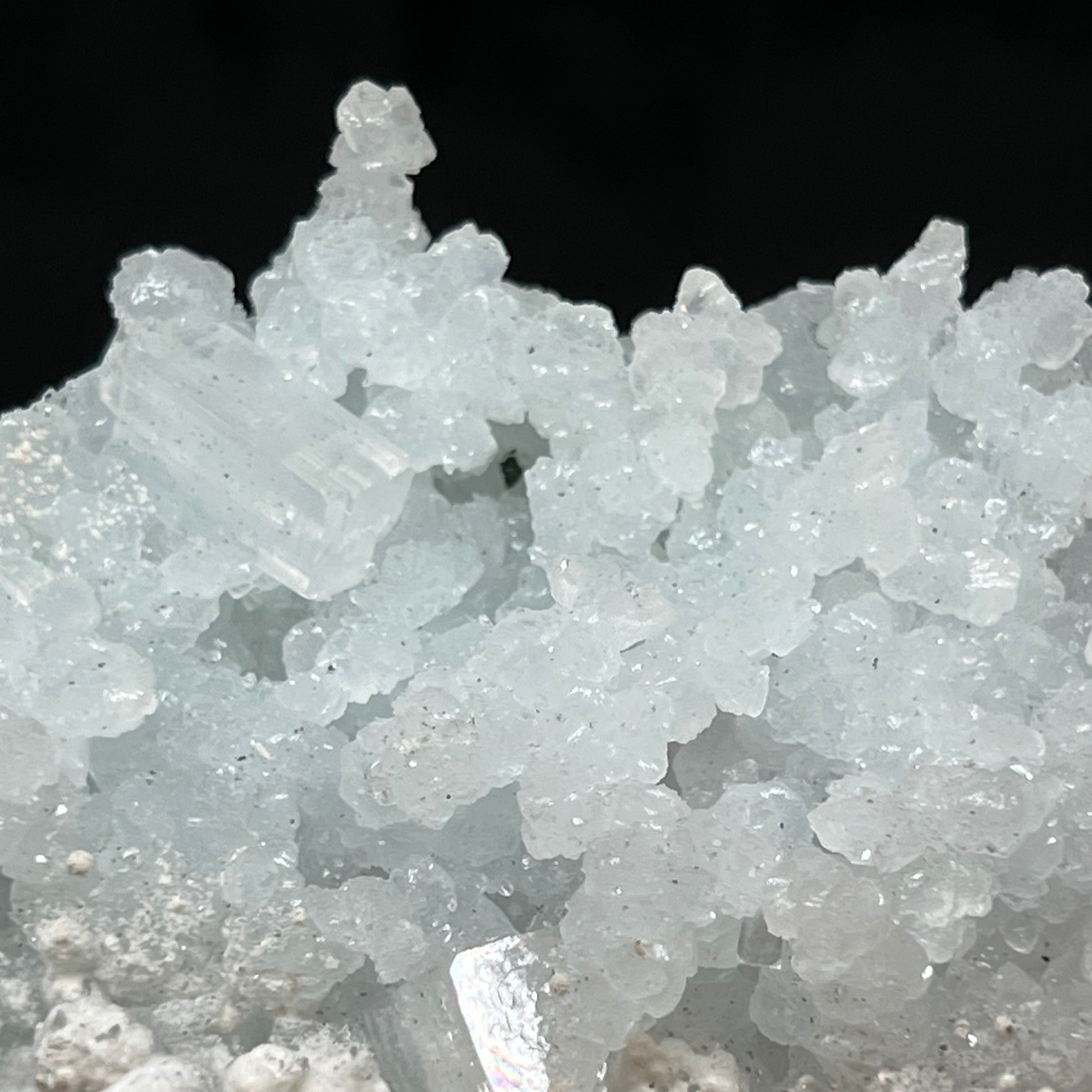 This fine Prehnite pseudomorph after Laumontite specimen features fascinating finger-like stalks, some stalactite-like, of pale, light blue-green Prehnite.