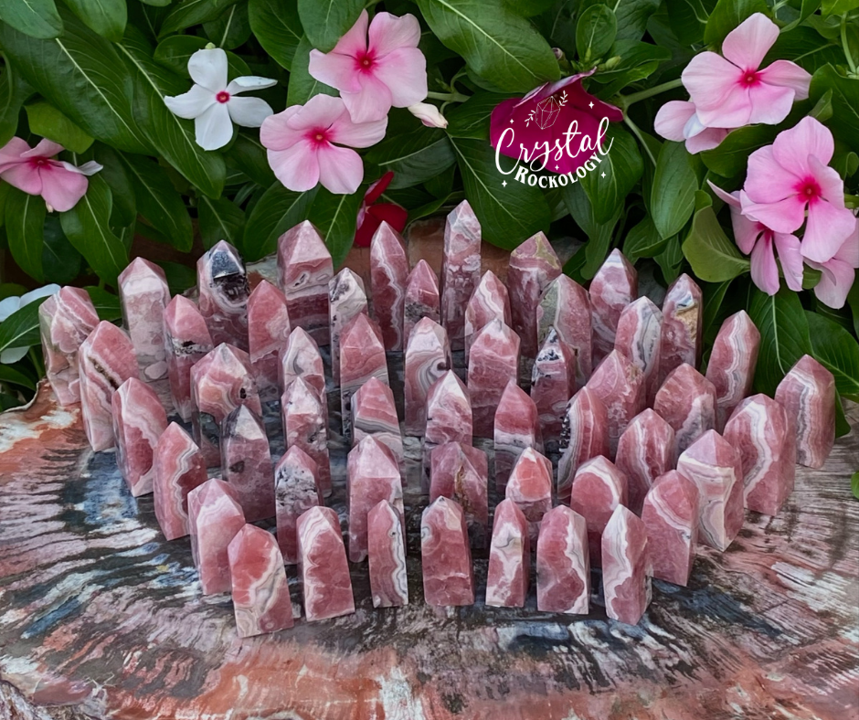 Rhodochrosite, polished obelisks or towers around 1.5-3" tall."