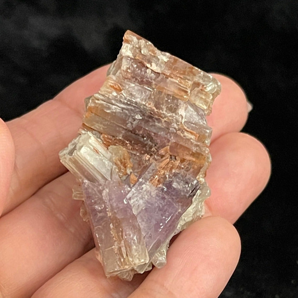 Purple Aragonite from Spain, shown in hand.