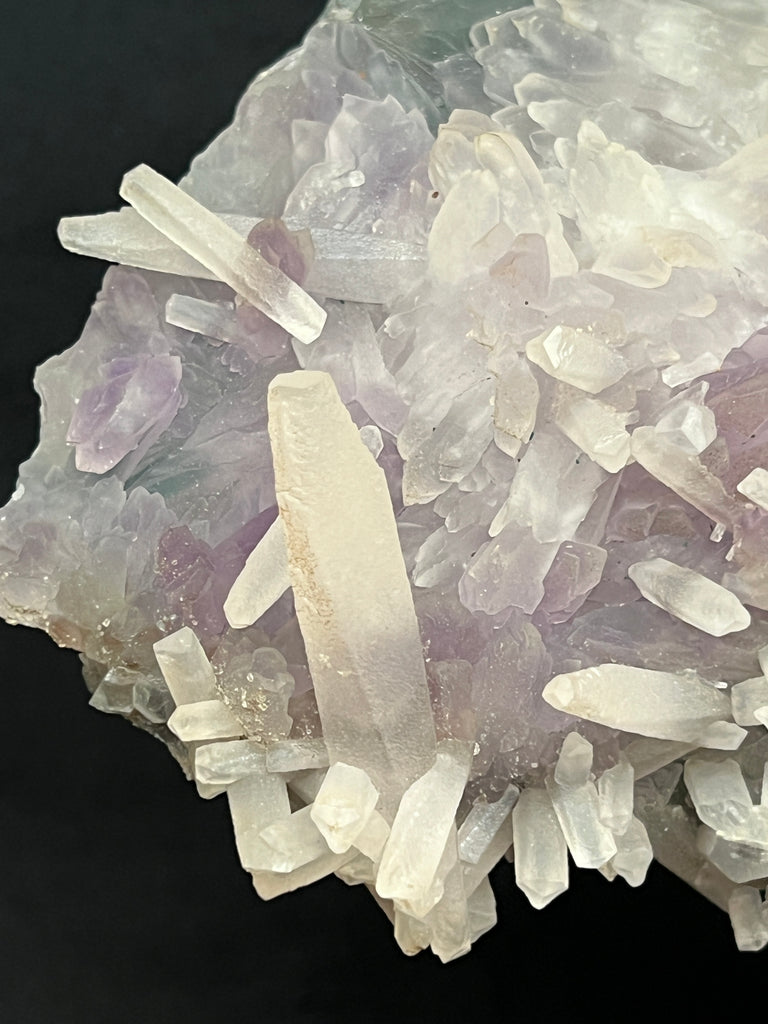 Double-terminated Calcite crystals with flattened pyramidal terminations are rare in Quartz variety Amethyst Flower specimens.