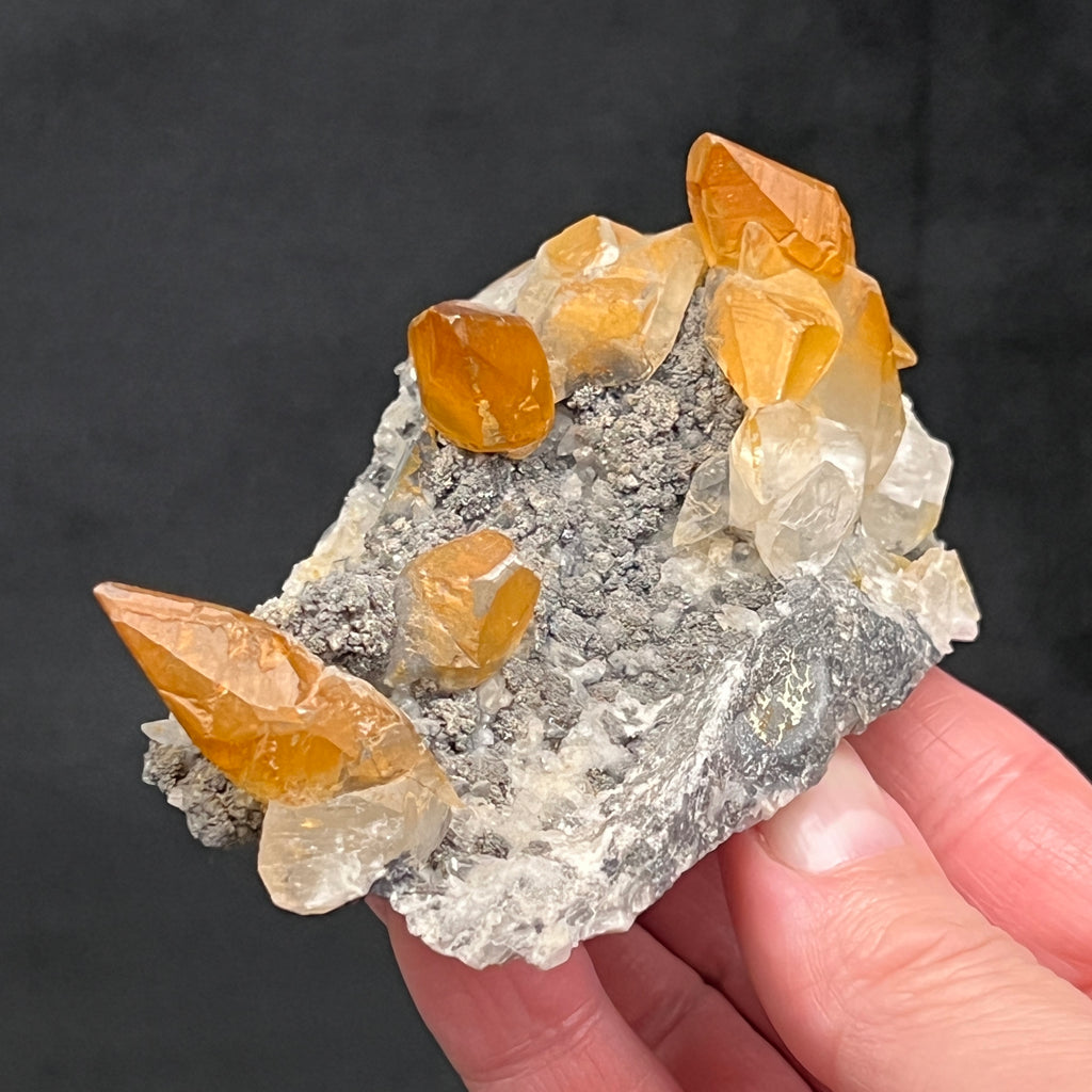 This Calcite has more of a satin luster rather than shiny, no doubt due to the influence of the hematite on the surface of the crystals.