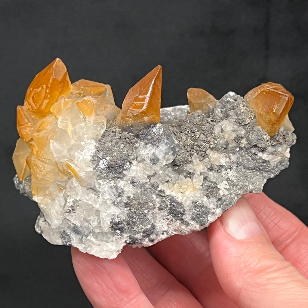 The red=orange color on these Calcite crystals is very magnetic to the eye, making this quite the fascinating specimen.