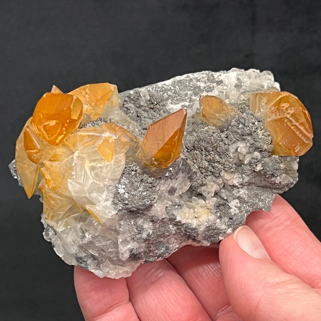 These Calcite crystals do show some fluoresence, glowing a pleasing yellow-orange color under UV light. 