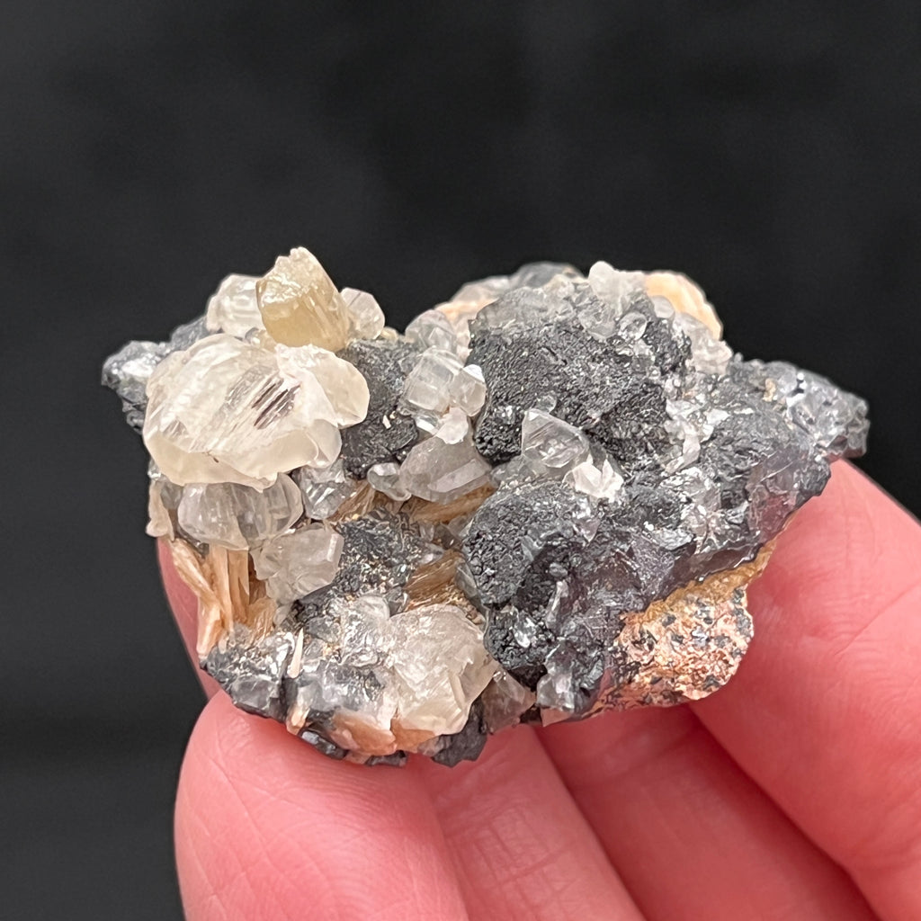 While Cerussite may be tan, light pale green, or light pale blue, the crystals in this specimen present as a distinctive translucent white, lightly yellow tinted hue, many of which are lustrous.