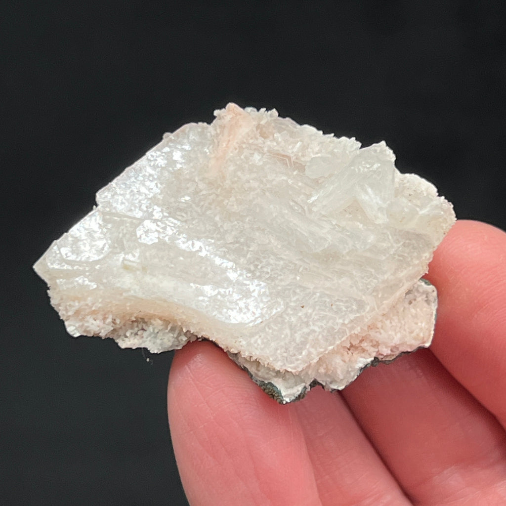 The stilbite crystals appear to congregate on one end of the piece, while the calcite is dispersed all over the surface of the heulandite.