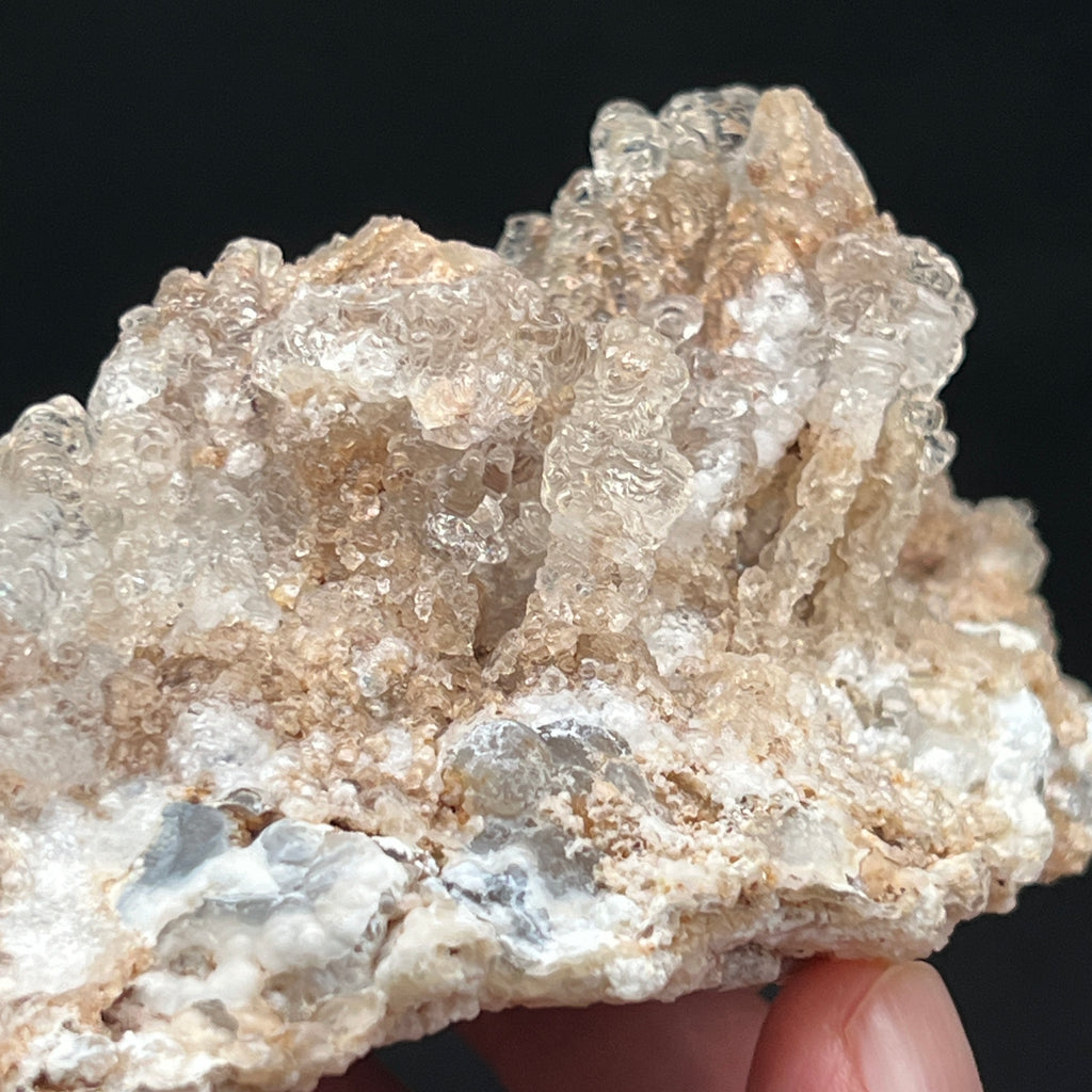 The Hyalite Opal is growing on what looks like an island of quartz var. chalcedony and much less of the usual rhyolitic tuff matrix that is often associated with this mineral formation.