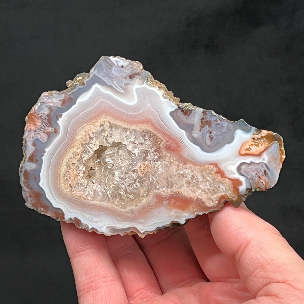 This is an outstanding, quality Moroccan Agate specimen, polished on one side, that presents with banding and sparkling, crystalline center growth and pocket.  