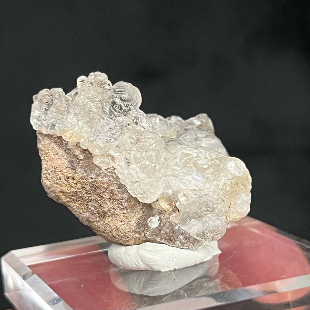 The botryoidal spherules are a hydrated silicate or solidified silica gel containing about 3 to 8% water. The solidification of Hyalite Opal culminates to a hardness of 5 to 6.5 on the Mohs scale, not far from the hardness of Quartz!