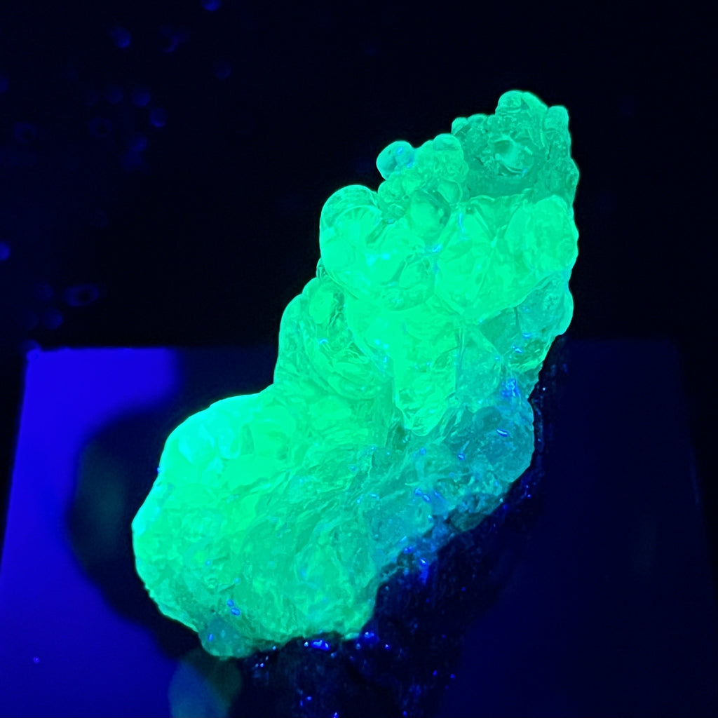 This is a 100% natural, high quality, translucent to transparent Opal variety Hyalite, a.k.a. Hyalite Opal, on Rhyolite Tuff matrix, with beautiful glassy, bubbly botryoidal habit that solidified into an overall wedge shape structure and fluoresces with a bright green glow when exposed to UV light.