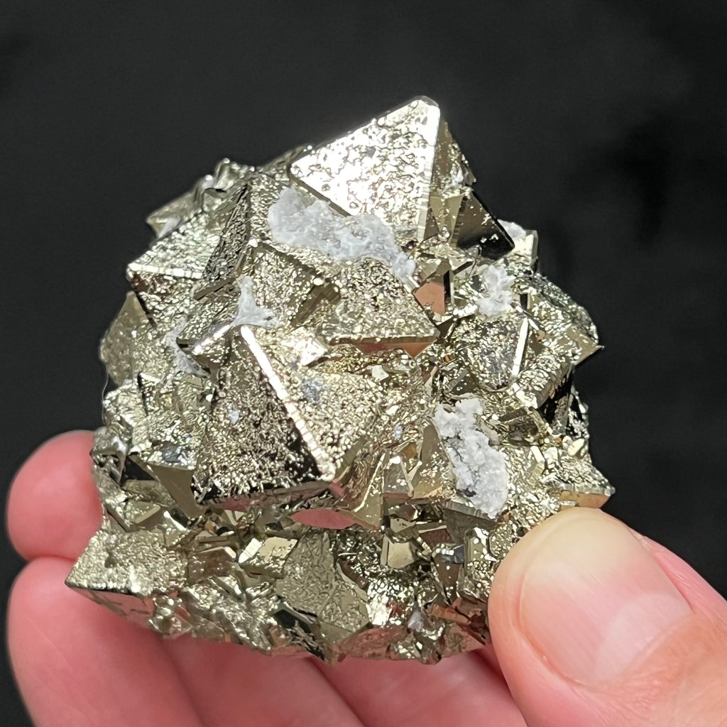 The quartz occurring between and on some of the Pyrite is a fascinating natural embellishment to this piece. The source for this exceptional, extremely bright octahedral Pyrite with polycrystalline growth is the Huanzala Mine, Huallanca, Bolognesi Province, Ancash, Peru.