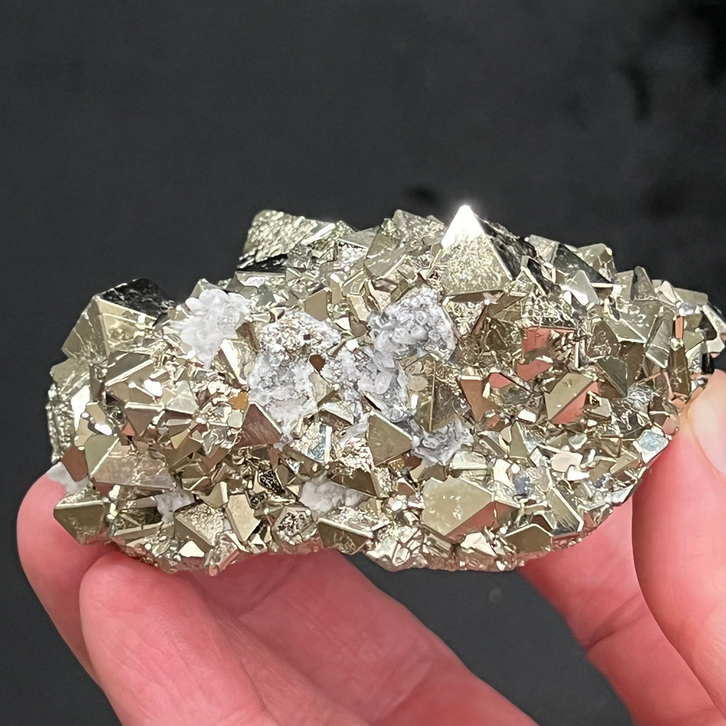 The quartz occurring between and on some of the Pyrite is a fascinating natural embellishment to this piece. The source for this exceptional, extremely bright octahedral Pyrite with polycrystalline growth is the Huanzala Mine, Ancash, Peru.