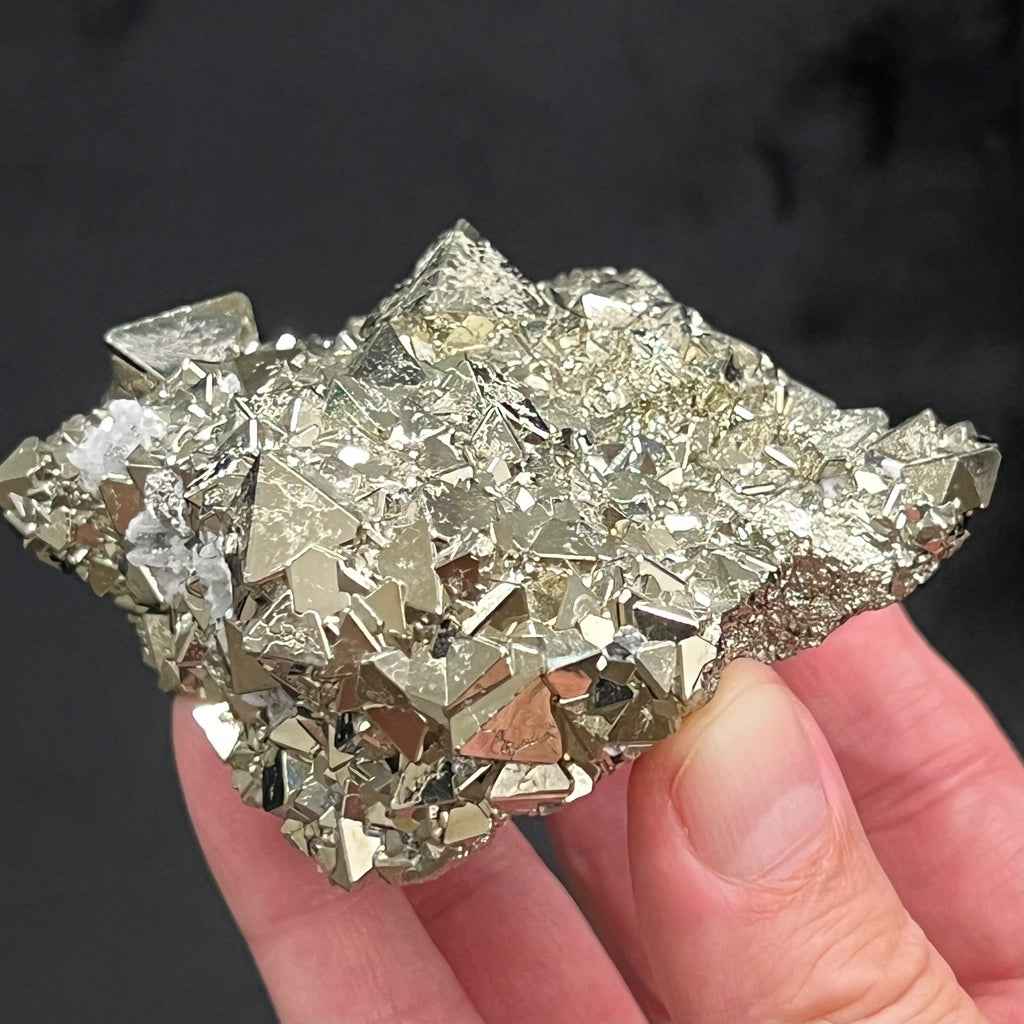 Some of the terminations and edges present with an intriguing, naturally occurring beveled structure and are not artificially altered in any way. The locality for this exceptional, extremely bright octahedral Pyrite crystals cluster with polycrystalline growth is the Huanzala Mine, Huallanca, Bolognesi Province, Ancash, Peru.
