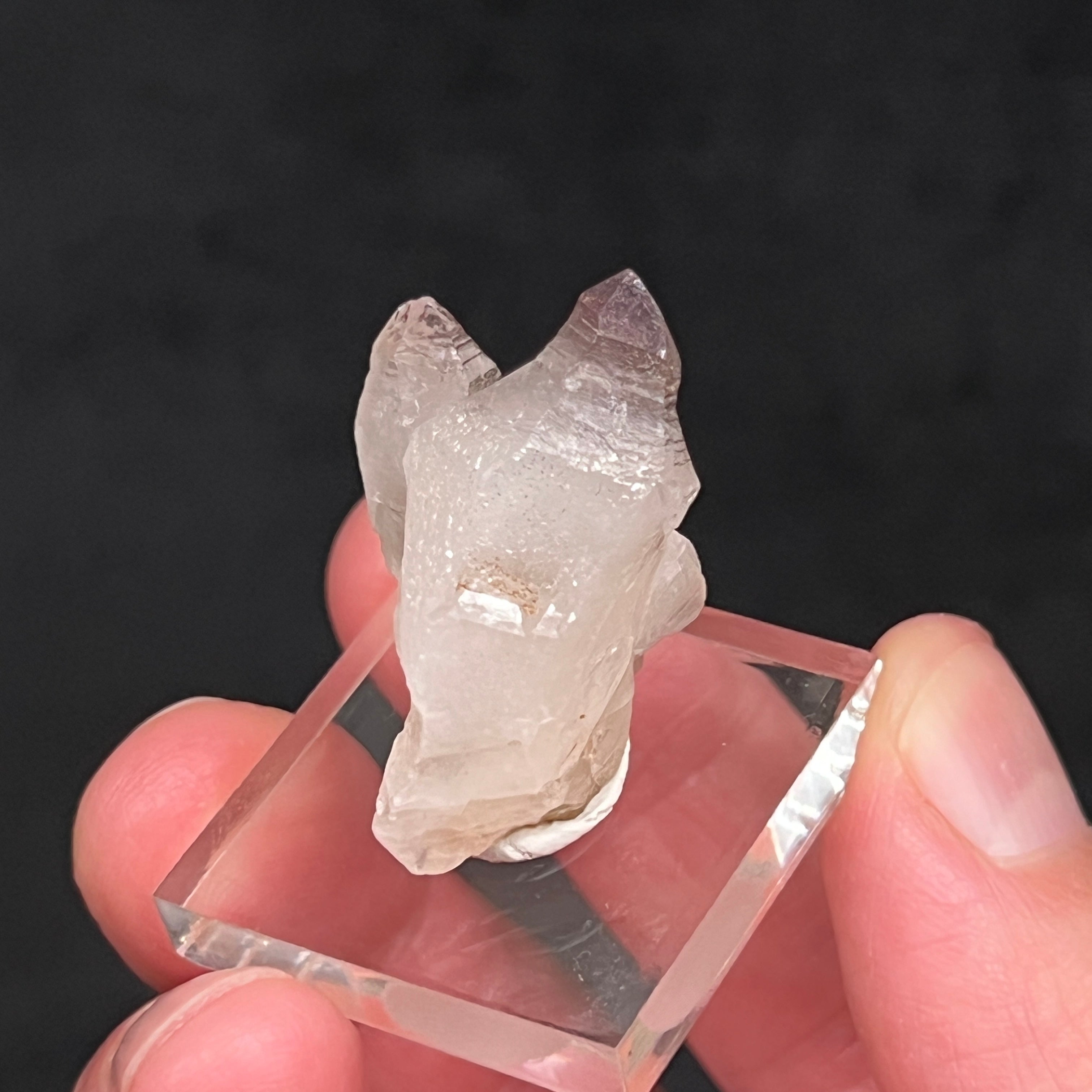 There are an incalculable number of specs and a "dusting" of hematite nestled in the sparkling drusy quartz and congregating more concentrated near the terminations.