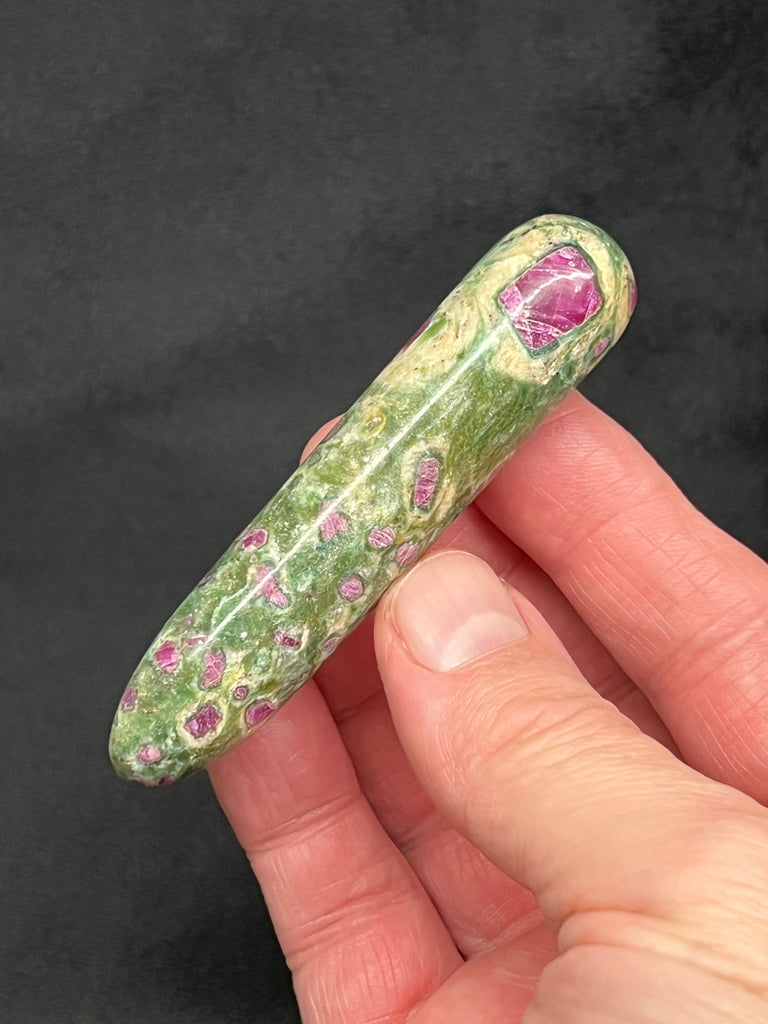This is a choice, quality, polished Ruby Fuchsite massage wand; carefully selected for the many rubies on all sides, beautiful and fascinating to see lit up when the rubies fluoresce a bright, hot pink under UV light. 