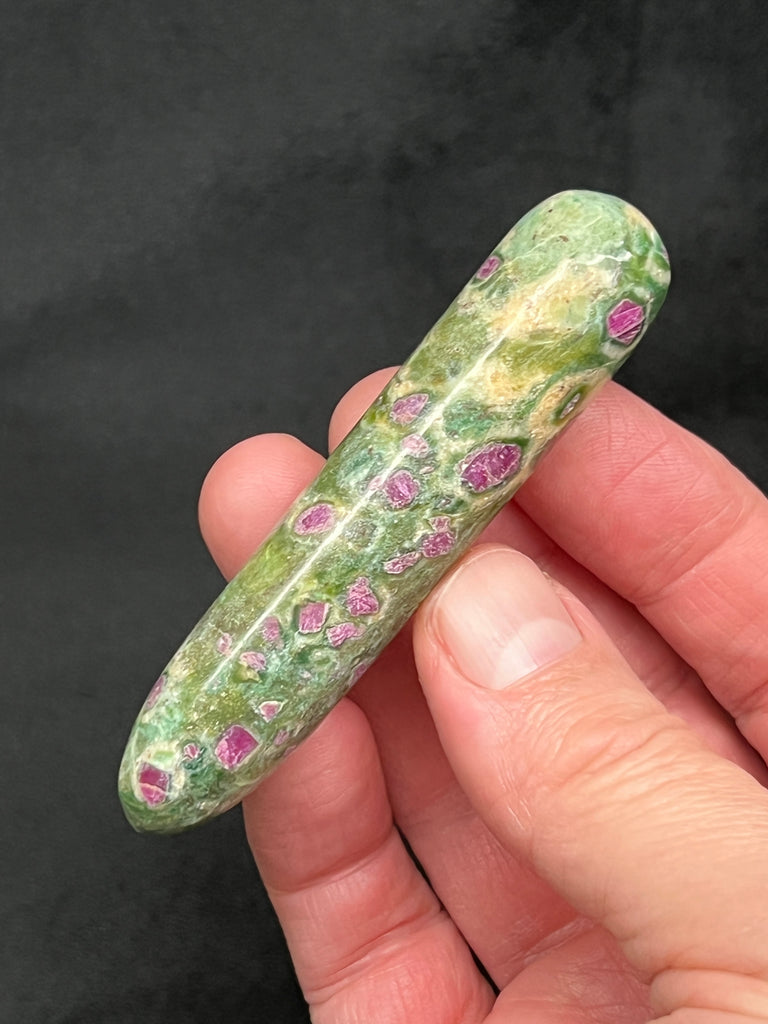 This polished Ruby Fuchsite massage wand was thoughtfully selected for quality, including choosing it for the abundance of rubies in the fuchsite.