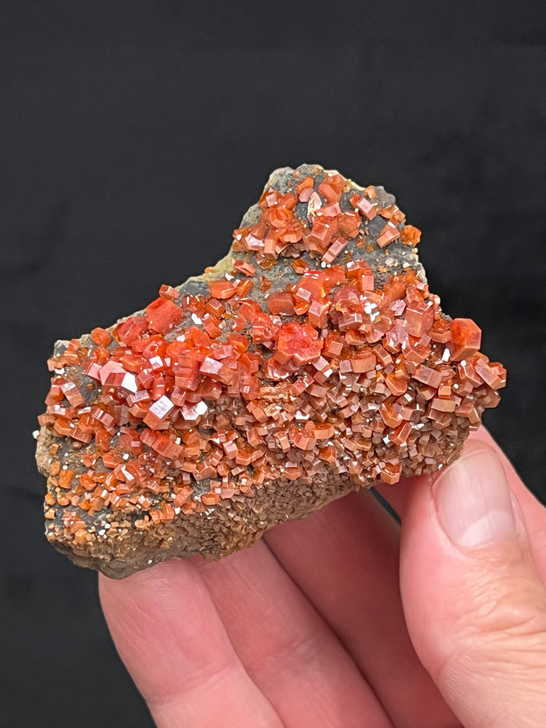 This is superb, lustrous Vanadinite specimen with many beautiful hexagonal prism crystals on natural Manganese Oxide coated Goethite on matrix.  The source for these excellent Vanadinite crystals is the Mibladen Mining District, Khenifra Province, Meknes-Tafilalet, Morocco.