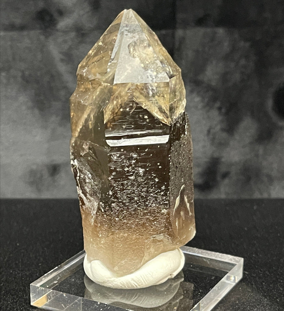 The edges of the faces and the termination of the secondary, upper, water clear Quartz are clean. The tip appears with a dip in it, it is not due to damage, it's caused by the atypical, stepped or staggered growth of the faces leading up to the termination.