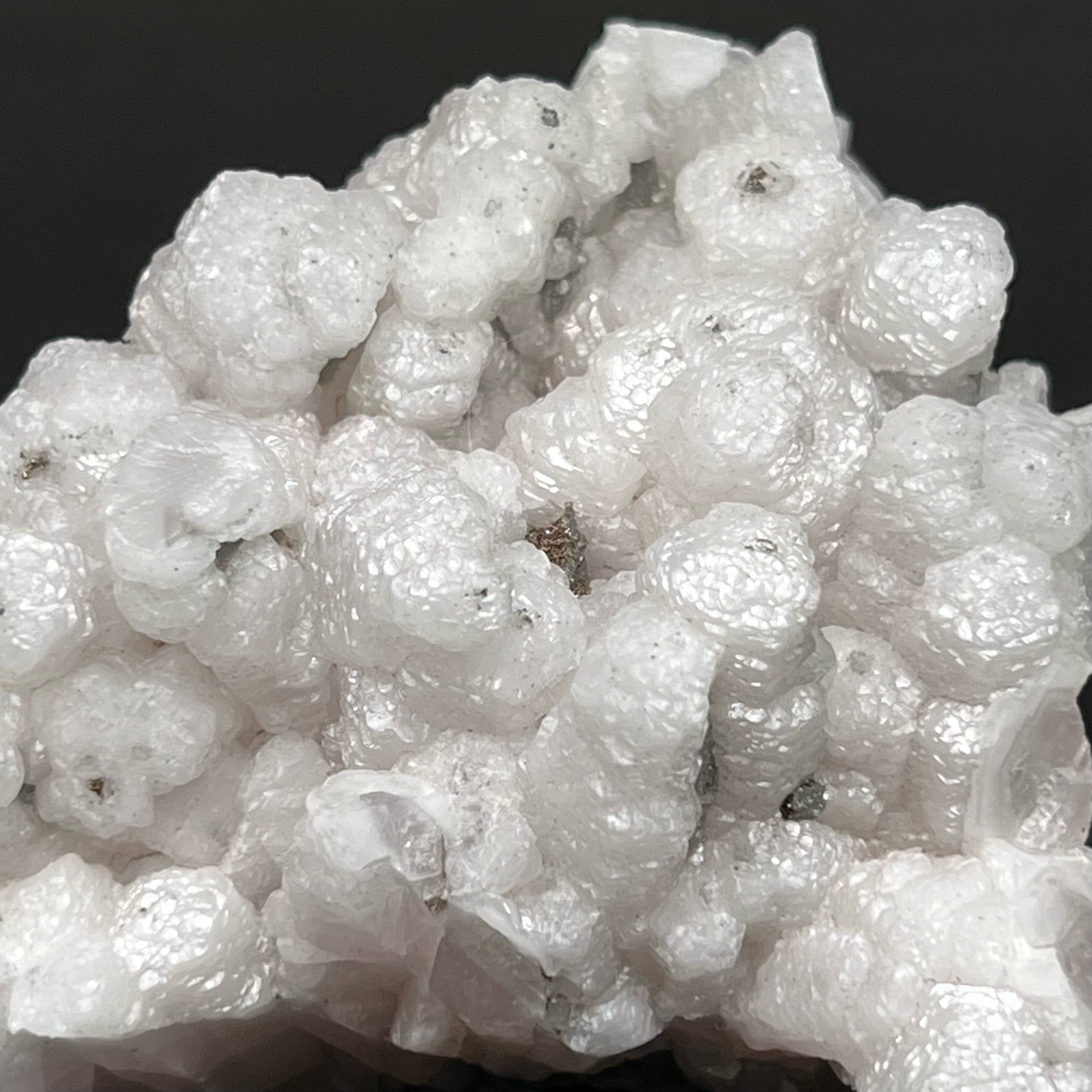 Each Poker Chip like Calcite crystal is growing "stacked" on top of another in a columnar fashion. 