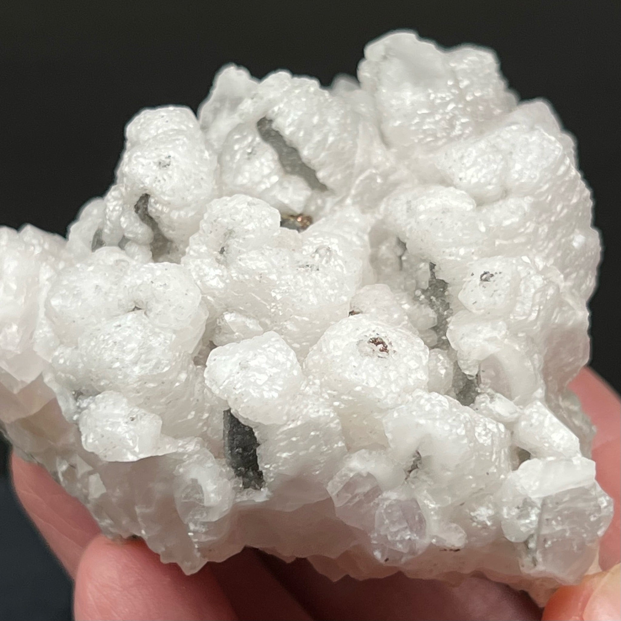 The centers of the hexagonal Calcite columns appear to have been a primary growth of scalenohedral Calcite, which was later covered in fine pyrite and chalcopyrite, and subsequently the columnar calcite grew on top of the other two "layers" of minerals. 