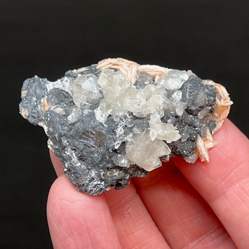 While Cerussite may be tan, light pale green, or light pale blue, the crystals in this specimen present as a distinctive translucent white, lightly yellow tinted hue, many of which are lustrous.