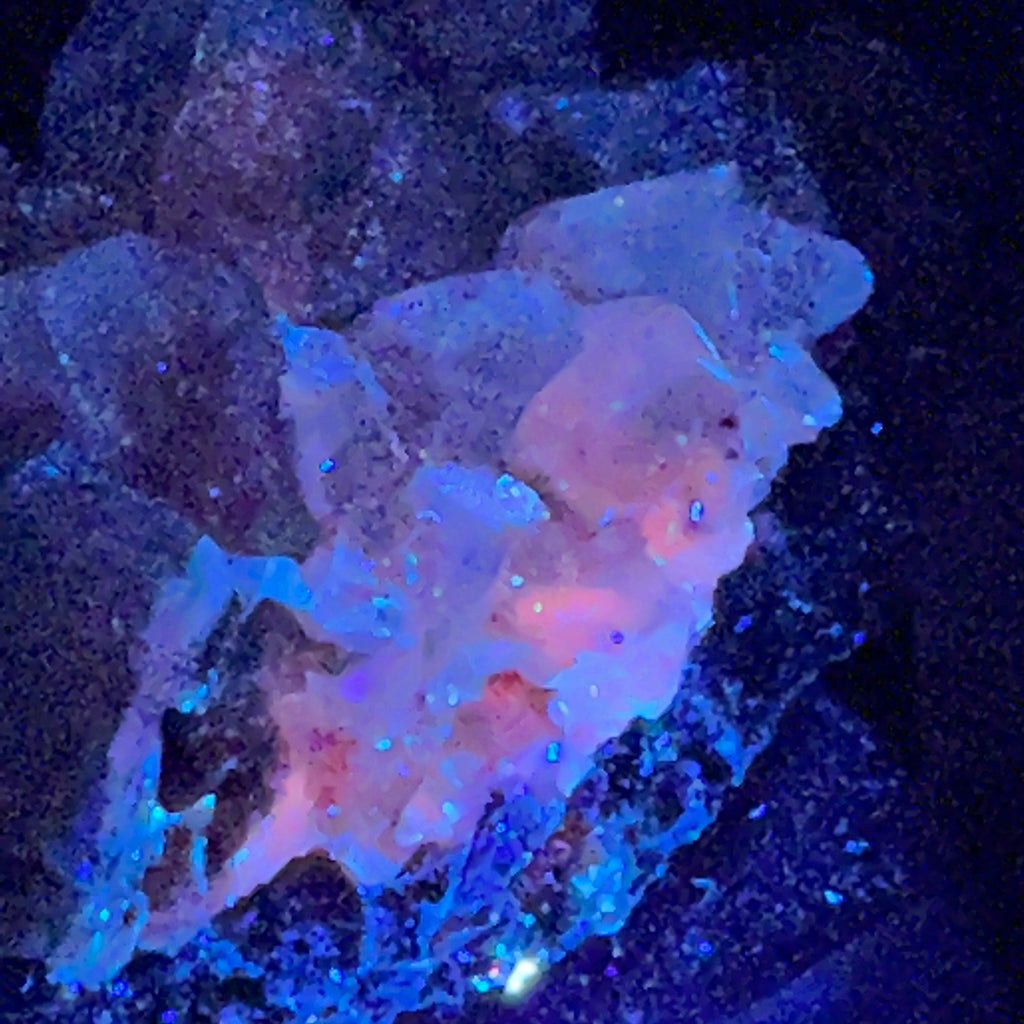 The interiors of the Calcite crystals where the Todorokite inclusions occur fluoresce a fascinating pink-orange color when exposed to UV light.