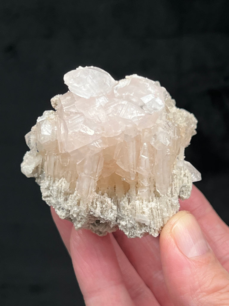 The stalactitic, icicle-like crystalline formation is exhibited all the way around this fine Calcite specimen from Dalnegorsk, Russia.