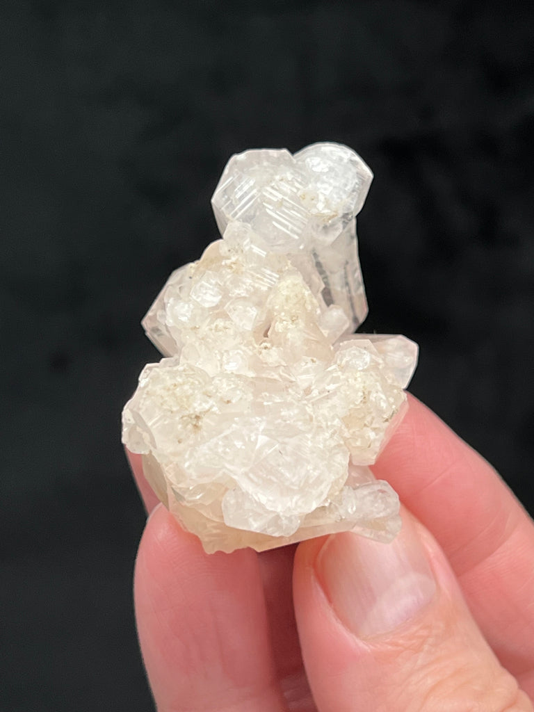 A close look reveals that another generation of Calcite crystals is growing on top of the rhombohedral crystals at the highest area of the cluster. 