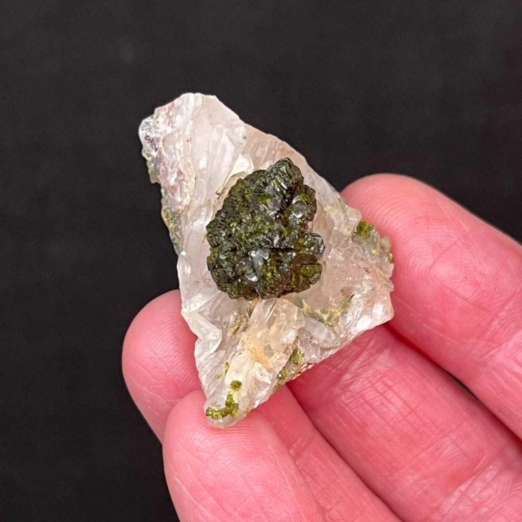 This is a quality, very aesthetic Epidote specimen with a dark green, roundish, ball-like, lustrous cluster of fan-shaped crystals perched centered on a bed of quartz crystals.