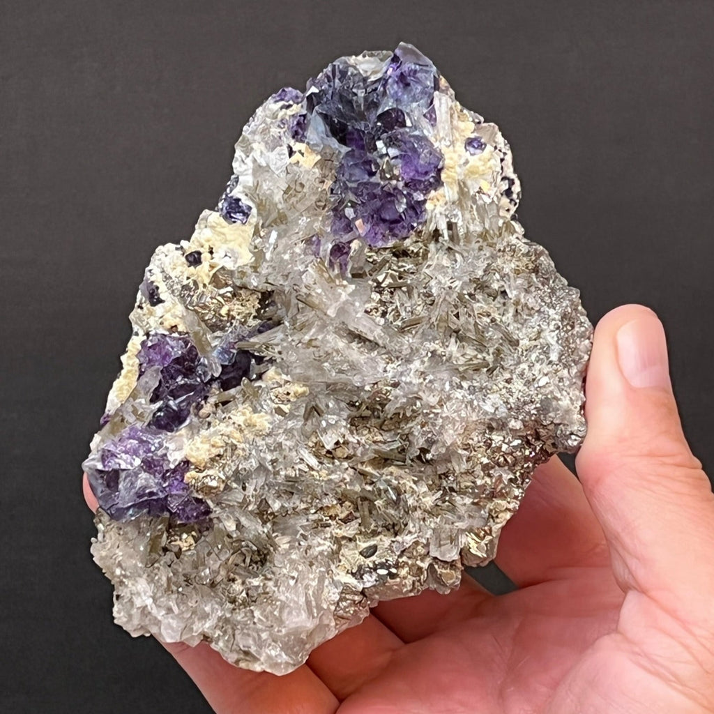 This an excellent combination specimen with lustrous, blue-purple, cubic Fluorite, Needle Quartz, Pyrite, Chalcopyrite and Muscovite.