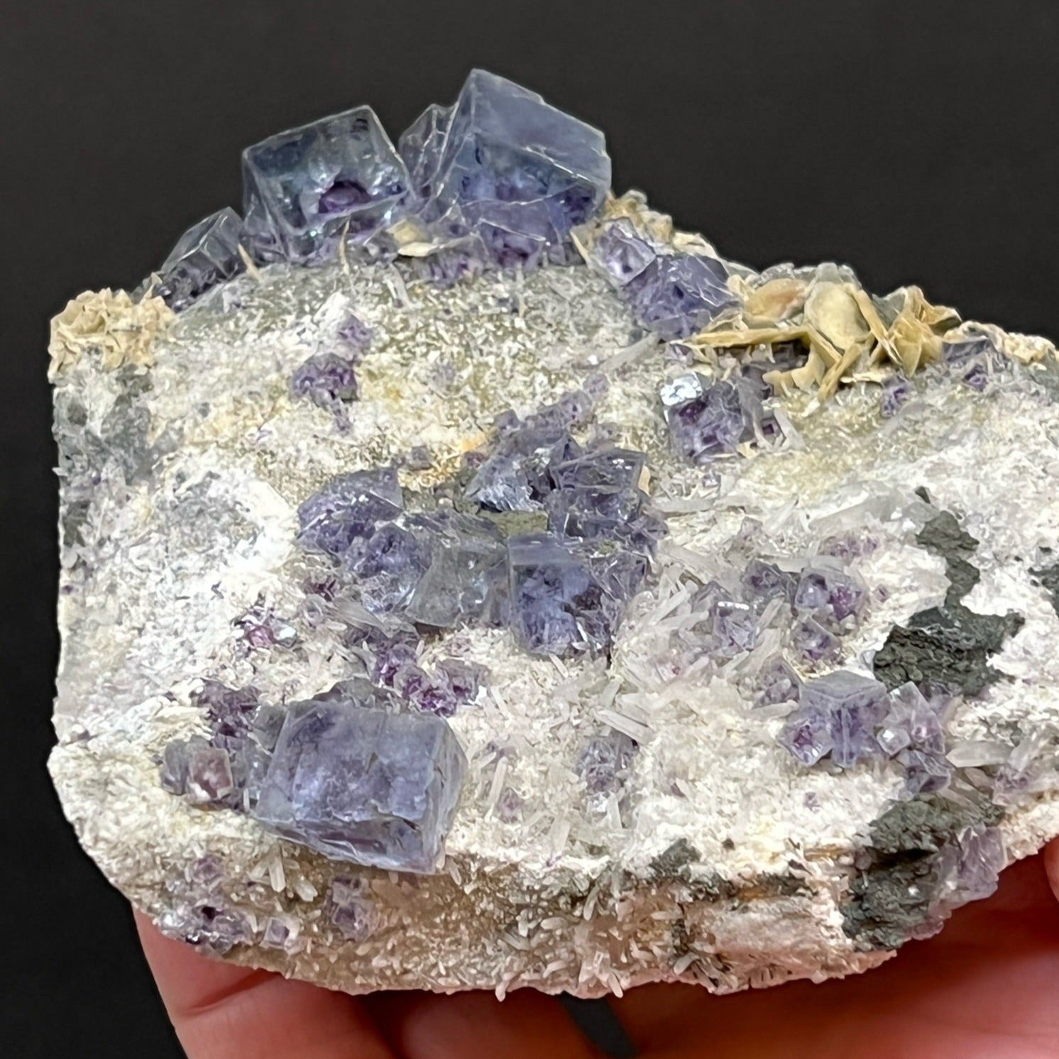 Those surfaces of Fluorite that exhibit etched and scaled surfaces appear to have a misty appearance while others are water clear transparent. 