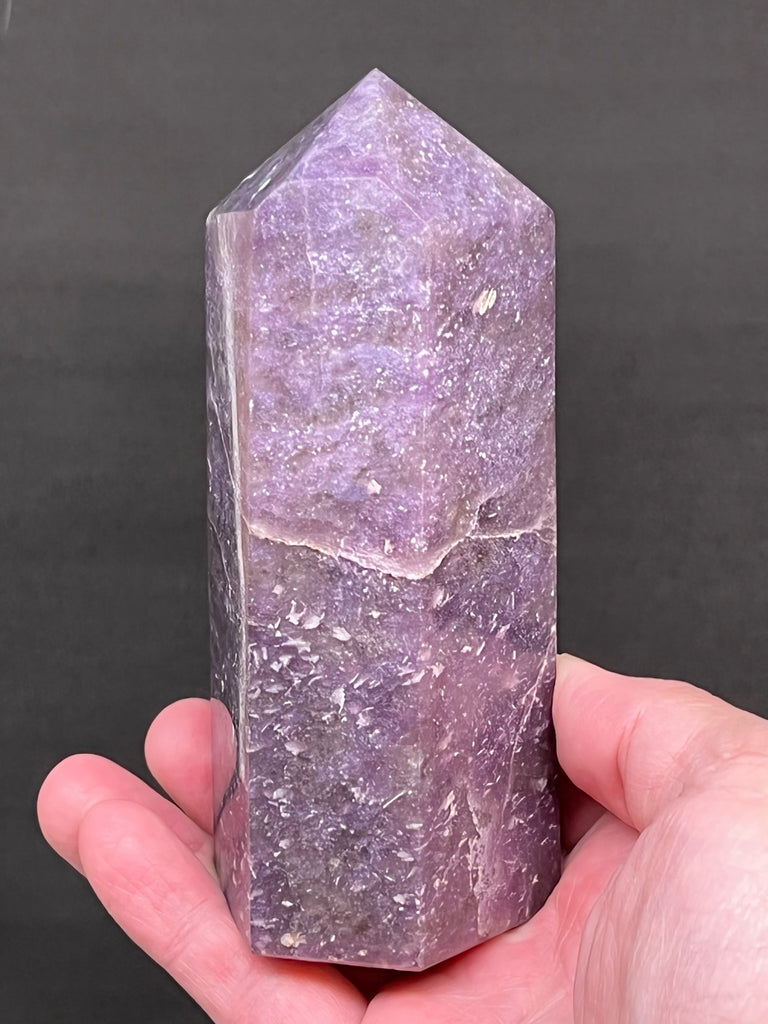 Not broken or cracked; the natural stress fractures that developed during the growth of the stone, add to the unique character of this fine example of Lepidolite.  