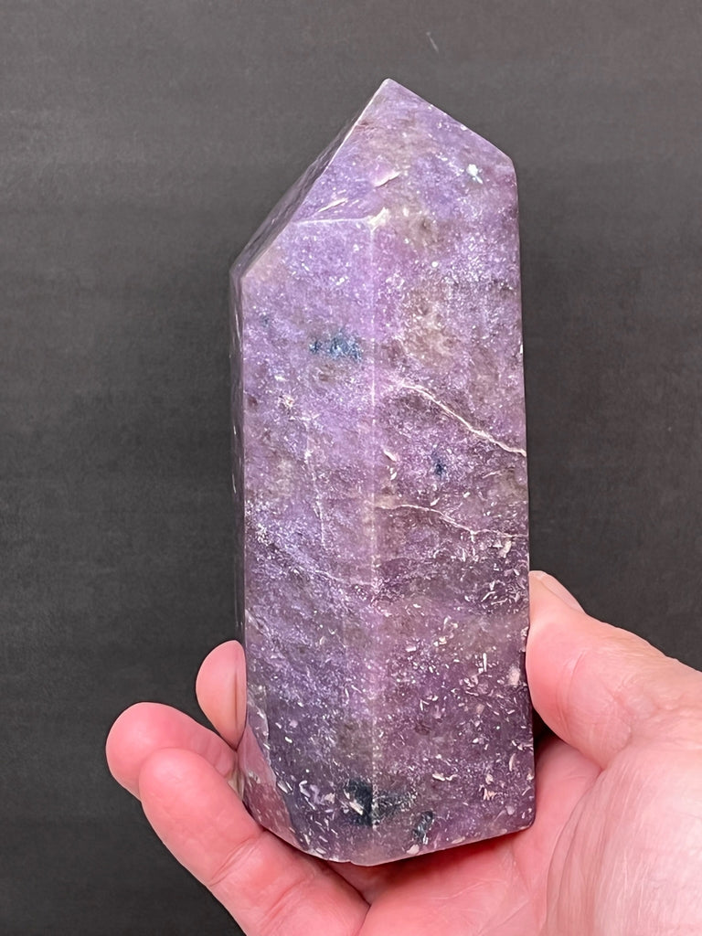 We love the soothing purple to dark purple, with a few dashes of Chromium rich green, that presents in this Lepidolite obelisk.