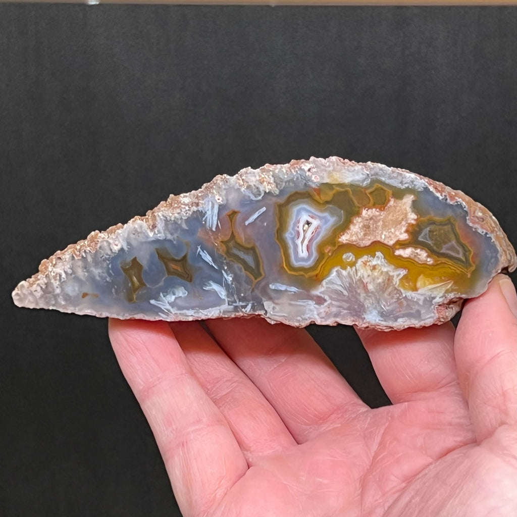 There is a beautiful dispersal of dark yellow-green banding and fortification interestingly spaced agate patterns presented in this Moroccan specimen.