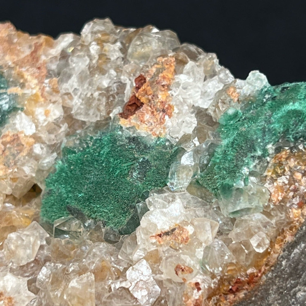 Small Cerussite crystals appear imbedded within a few of the shallow pockets of Quartz and near the Malachite..  