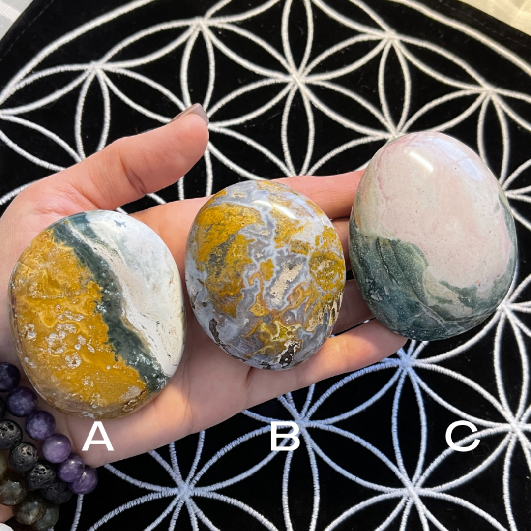 Ocean Jasper large Palmstones, three shown in hand, each different.