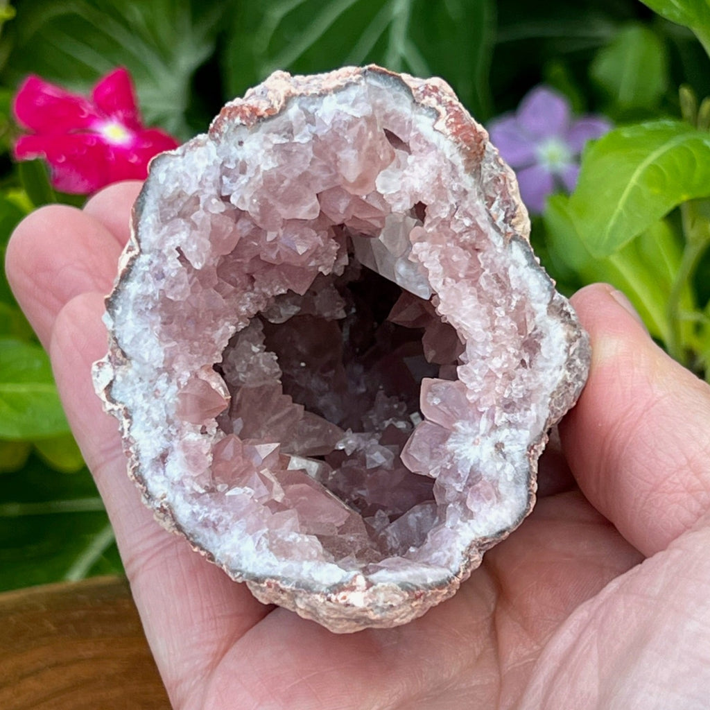 This is a cavernous, quality, beautiful Pink Amethyst Crystals Geode specimen featuring wonderful depth, exceptionally well formed water clear calcite crystals near the edge of the specimen and a secondary growth small calcite crystals bridge deep in the pocket. 