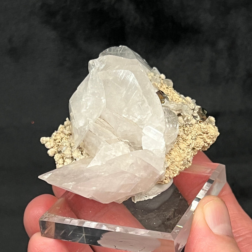The Calcite has sharp edges and some of the crystals present stacked or layered vertically.