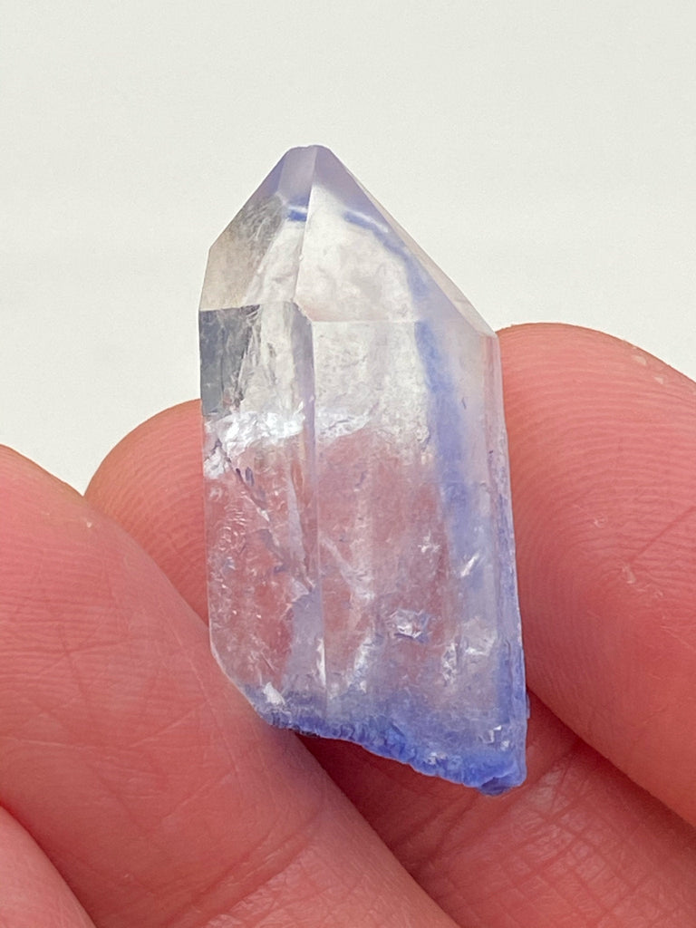 This example of Dumortierite in Quartz is comprised of Quartz that exhibits good clarity which presents the opportunity to see the Dumortierite occurring within and on the base and scattered on some of the facets of the Quartz crystal. Source: Vaca Morte Quarry, Serra de Vereda, Boquira, Bahia, Brazil